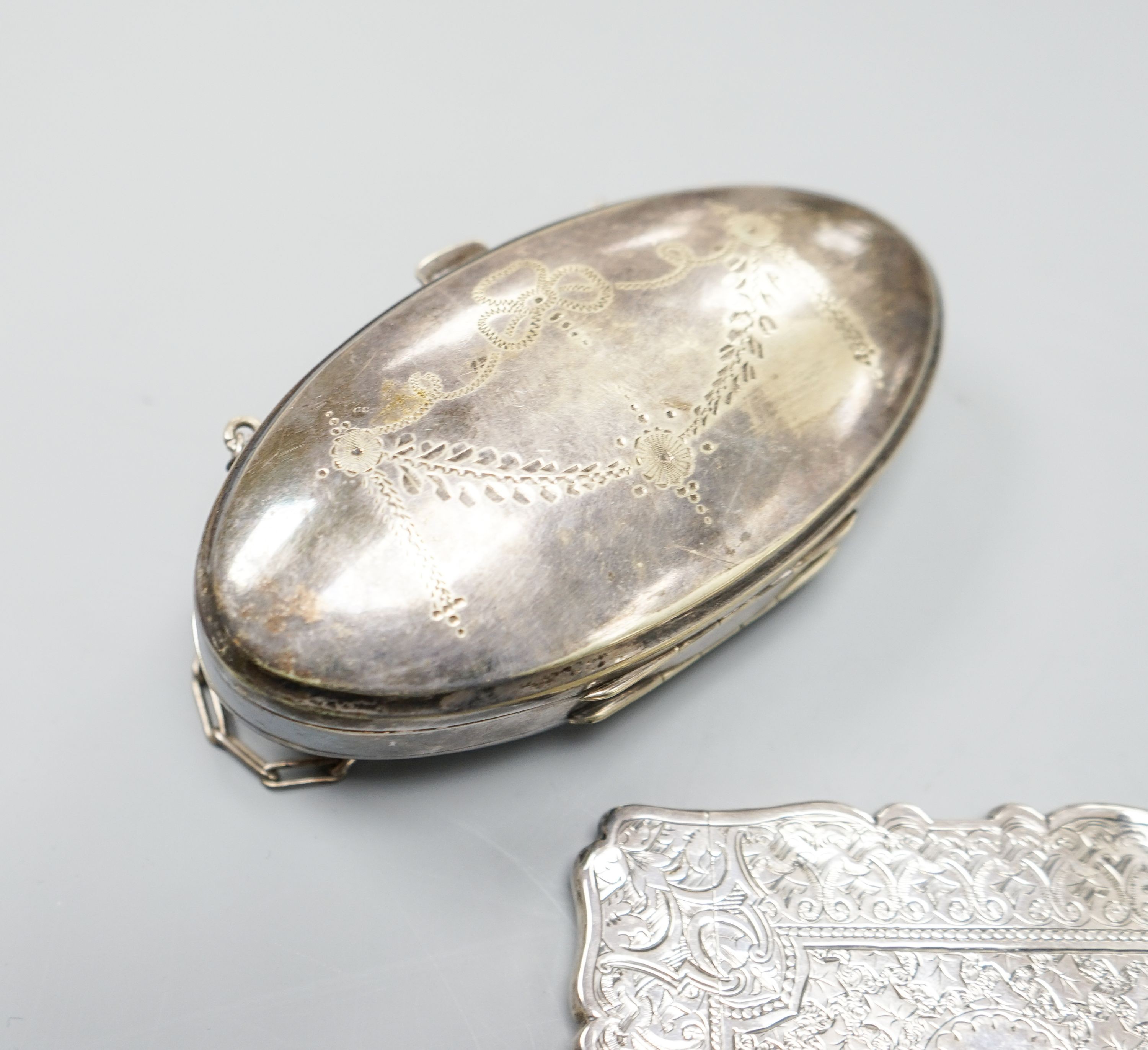 A late Victorian engraved silver card case, Birmingham, 1877, 10cm, a silver mesh evening purse and two other plated items.